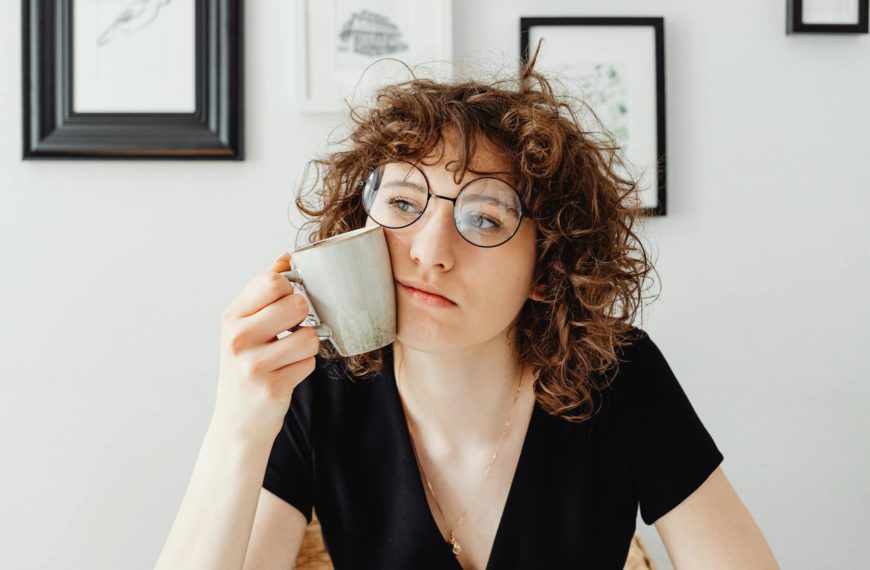 Curly-Haired Woman Holding a Coffee Mug